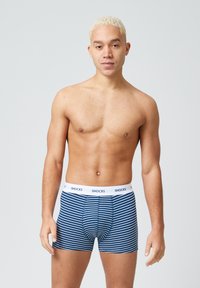 Boxer briefs in navy blue with white stripes, made of soft fabric. Features a white elastic waistband with the brand name "SNOCKS" printed.