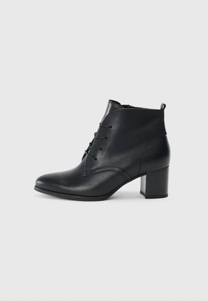 Black leather ankle boot with lace-up front and block heel, smooth finish, and pull tab at the back against a plain background.