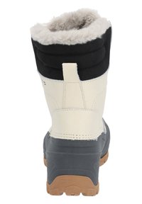Black and cream waterproof boot with plush white fur lining, padded collar, and textured rubber sole for grip. Reinforced heel and ankle support.