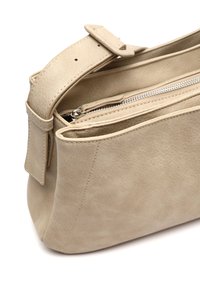 Borsa a mano beige in pelle con una texture liscia, dotata di una chiusura con zip, tracolla regolabile e dettagli di cucitura minimali.