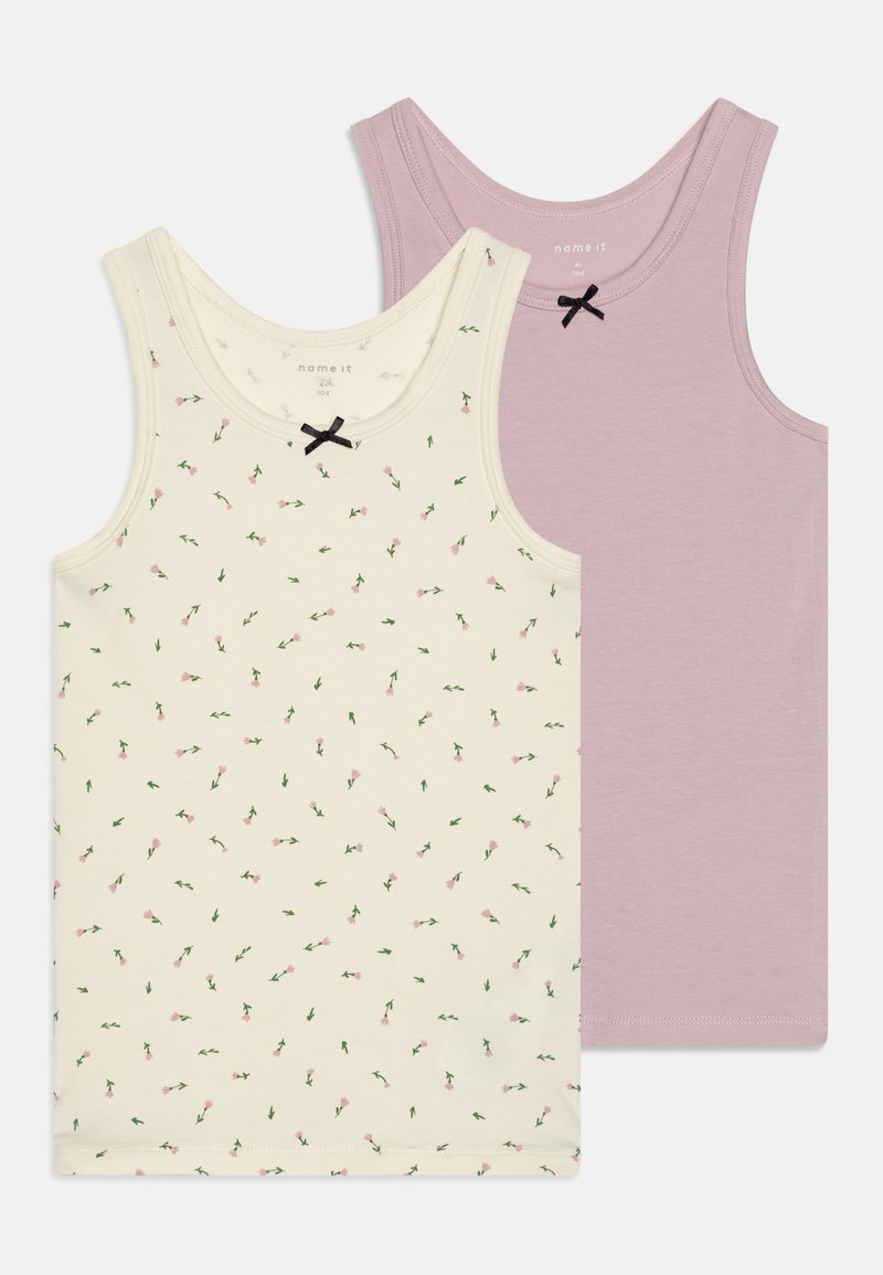 Two tank tops: one in cream with pink floral pattern and green leaves, featuring a small black bow; the other in solid light purple.