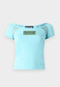 Light blue, short-sleeve t-shirt with a fitted design. Features mesh accents on shoulders and an embroidered logo patch at the front.