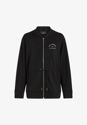 Sweat à capuche noir zippé avec poches avant, taille à cordon de serrage, et texte blanc "Karl Lagerfeld Paris 21 Rue St-Guillaume" sur le côté gauche de la poitrine.