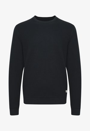 Czarna sweatshirt o teksturowanej powierzchni z okrągłym dekoltem, ściągaczami przy mankietach i dolnym brzegu. Posiada małą metkę marki po jednej stronie. Klasyczny krój.