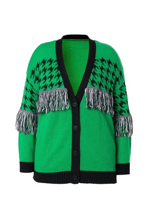 Zelený pletený kardigan s černým houndstooth vzorem a třásněmi na rukávech. Má výstřih do V, černé knoflíky a žebrovaný lem.