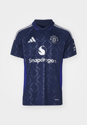 Dark blue polo football shirt with a geometric pattern, featuring white "Snapdragon" logo and Manchester United crest. Adidas three stripes on sleeves.