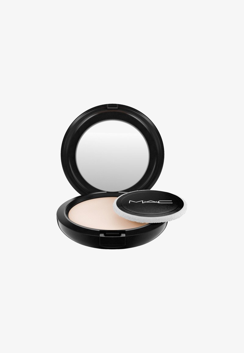 MAC gepresstes Puder in schwarzem Kompakt. Verfügt über ein glattes, cremefarbenes Puder und einen runden Makeup-Applikator mit schwarzer Rückseite und weißem Rand.