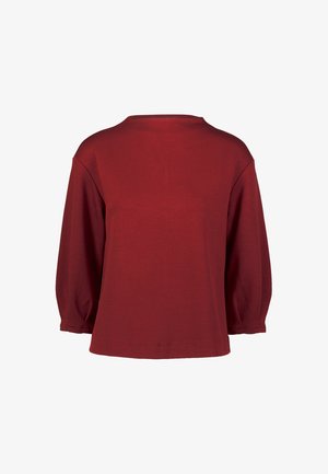 Bordeaux oversized pullover med trekvartærmer, rund halsudskæring og glat tekstur. Ingen synlige mønstre eller metaldele.