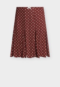 Bruine rok tot op de knie met witte polka dots, uitlopende zoom en een klein wit strikje aan de elastische tailleband.