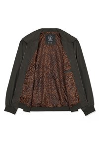 Veste noire zippée avec doublure intérieure à motifs orange et noir et étiquette de la marque Volcom à l'intérieur du col.