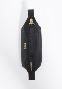 Schwarze Textil-Tasche mit goldenem Reißverschluss und geprägtem Branding. Hat eine strukturierte Form und eine glatte Textur. Der Reißverschluss-Zipper ist aus Metall.