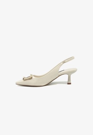 Beige patent leather slingback pump with pointed toe, low curved heel, and gold decorative buckle on the front.
