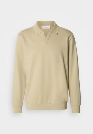 Polo a maniche lunghe beige con colletto, caratterizzata da un design con scollo a V e polsini a coste. Realizzata in tessuto morbido con una texture liscia.