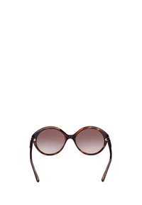 Occhiali da sole tortoise marrone con forma ovale, lenti sfumate, aste sottili e sottili accenti metallici alle cerniere.
