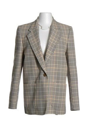 Blazer de cuadros beige y marrón de un solo botón con solapas anchas, exhibido en un torso de maniquí blanco.