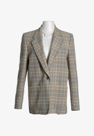 Veste à carreaux beige et marron à un bouton avec de larges revers, présentée sur un torse de mannequin blanc.