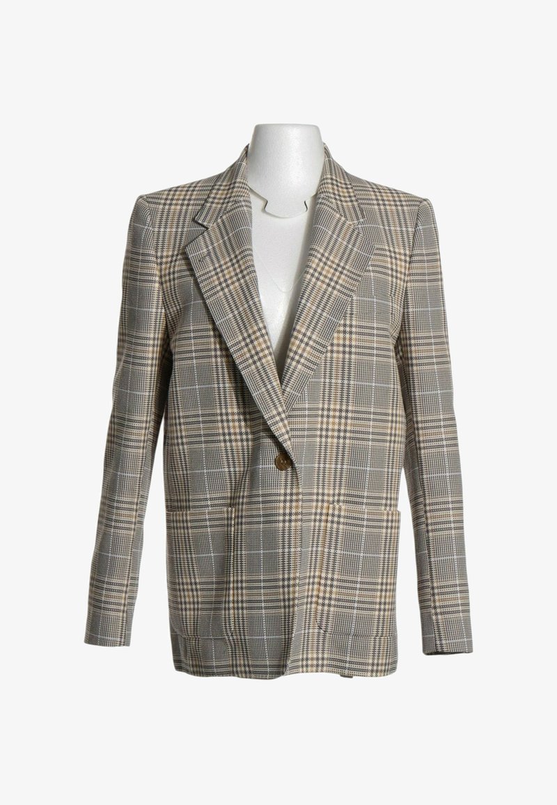 Veste à carreaux beige et marron à un bouton avec de larges revers, présentée sur un torse de mannequin blanc.