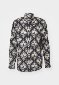 Maglietta a maniche lunghe con bottoni di colore blu navy con un ornato motivo damascato avorio. Realizzata in tessuto leggero con colletto strutturato e maniche con polsini.
