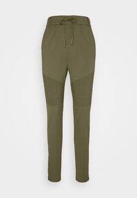 Olivgrüne Jogginghosen aus weichem Material, mit einem Kordelzugbund und gerippten Akzenten an den Unterschenkeln, schmal zulaufender Schnitt.