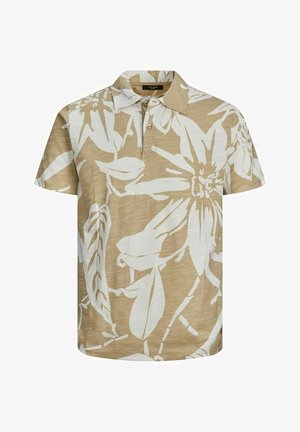 Polo à manches courtes en beige avec de grands motifs floraux blancs, doté d'un col et d'une patte de boutonnage à trois boutons. Tissu texturé.