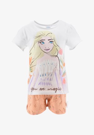 T-shirt bianca in cotone con una stampa colorata di un personaggio circondato da fiori e la scritta "sei magia", abbinata a pantaloni corti pesca con un motivo a castello.