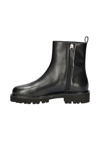 Bottines noires en cuir avec fermeture éclair sur le côté, bout rond et semelle en caoutchouc épaisse présentant un motif texturé pour une meilleure adhérence.