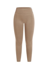 Beige leggings med høj talje, lavet af strækbart materiale, med sømdetaljer langs siderne og en glat tekstur.
