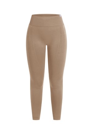 Beżowe legginsy z wysokim stanem, wykonane z elastycznego materiału, z przeszyciami wzdłuż boków i gładką fakturą.