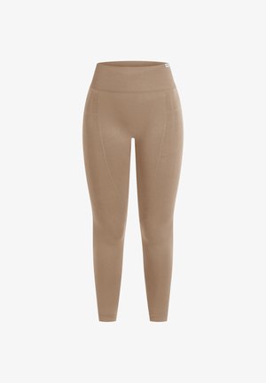 Beżowe legginsy z wysokim stanem, wykonane z elastycznego materiału, z przeszyciami wzdłuż boków i gładką fakturą.