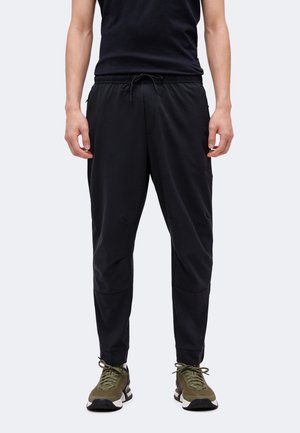 Nike Performance UNLIMITED - Tepláky - black