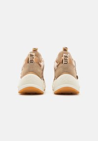 Light brown sneakers with a padded design, cream outsole, and contrasting "BUF" labels on the heel. Textured fabric and sleek silhouette.
