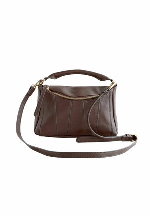 Brown leather handbag with a zip closure, featuring vertical seam detailing, a short carry handle, and an adjustable shoulder strap.