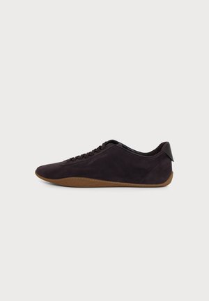 Low-profile dark brown suede sneaker with matching laces and light brown textured rubber sole, displayed on a light background.