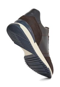 Brown suede and leather athletic shoe with a textured rubber sole, featuring a contrasting white midsole and detailed stitching.
