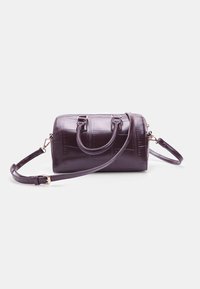 Dark purple, glossy handbag with a cylindrical shape, dual top handles, and a detachable shoulder strap. Features textured surface details.