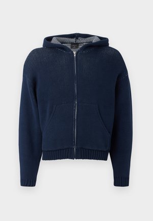 Dark blue zip-up hoodie with a textured knit design, ribbed cuffs, and front pockets. Features a contrasting hood lining.