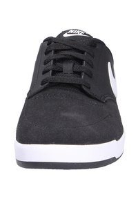 Black suede skate shoes with a white rubber sole. Features a classic lace-up design and a black Nike logo on the tongue.