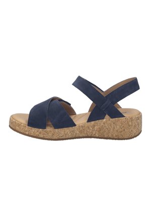 Marineblauwe suède sandaal met sleehak en brede gekruiste bandjes, kurken platformzool, enkelbandje voor ondersteuning en gevoerde binnenzool.