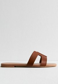 Bruine neplederen slipper met open teen ontwerp, met een brede band en uitsnijdingaccent. Platte zool met een gladde textuur.