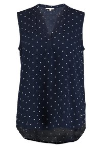 Mörkblå ärmlös blus med vitt stjärnmönster, V-ringad krage och rundad nederkant.