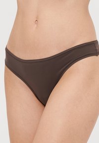 Smeđe donje dijelove bikinija odlikuje klasičan kroj, glatka tekstura i minimalno šivanje. Dizajnirani su za udobnost i sigurno prianjanje.