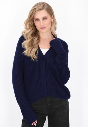 Navy blue knit cardigan with a v-neck, single button closure, and long sleeves. Features ribbed texture and a relaxed fit.