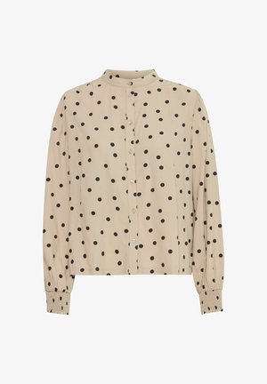 Beige garš sleeves blūze ar melniem punktiņiem, pogu priekšpuse, stāvošā apkakle un elastīgas aproces. Mīksta auduma ar gludu tekstūru.