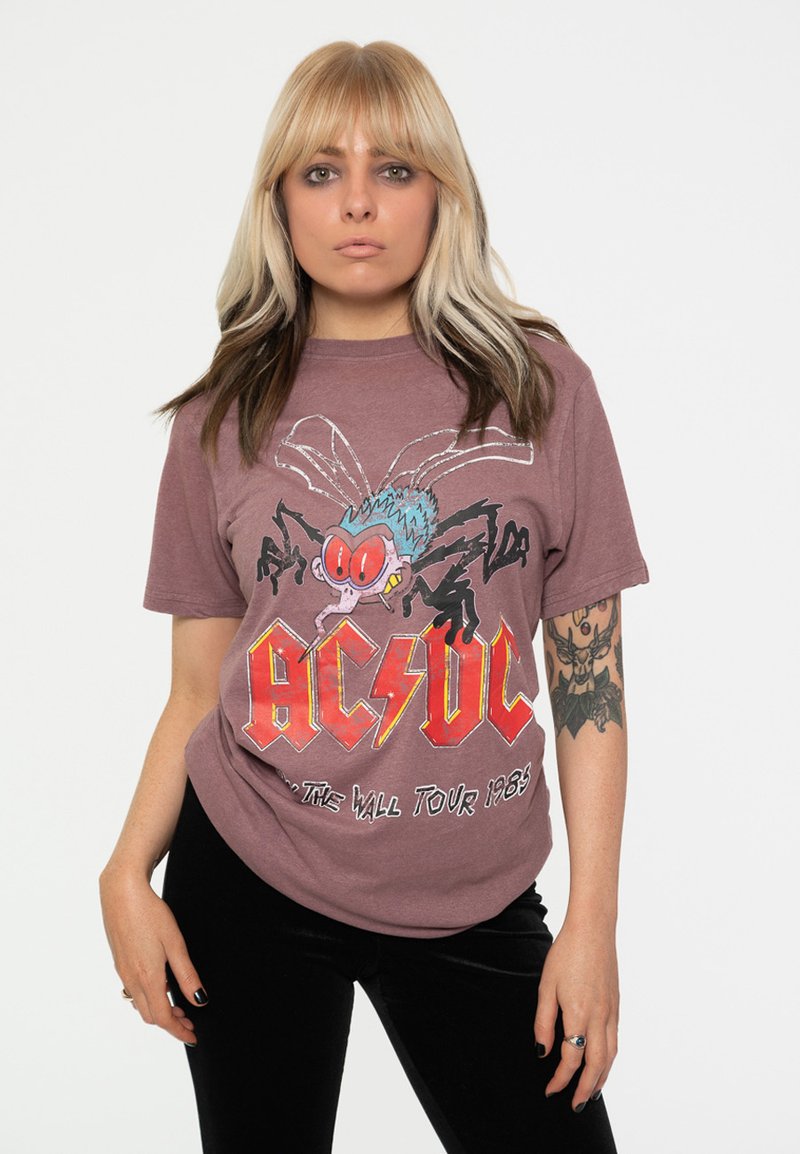 Cotton graphic t-shirt in mauve, featuring a cartoon spider design, "AC/DC" logo in red and yellow, and "The Wall Tour 1983" text.