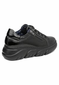 Sneaker in pelle nera con finitura testurizzata, punta rotonda e suola in gomma spessa e rigata. Presenta un design con lacci e una decorazione con zip di lato.