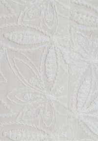 White embroidered fabric featuring floral patterns with textured detailing, creating a layered effect. Smooth and lightweight texture.