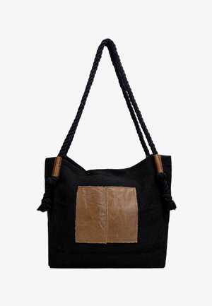 Borsa tote in tessuto nero con manici in corda intrecciata, toppe in pelle marrone sul davanti e dettagli in pelle nei nodi dei manici.