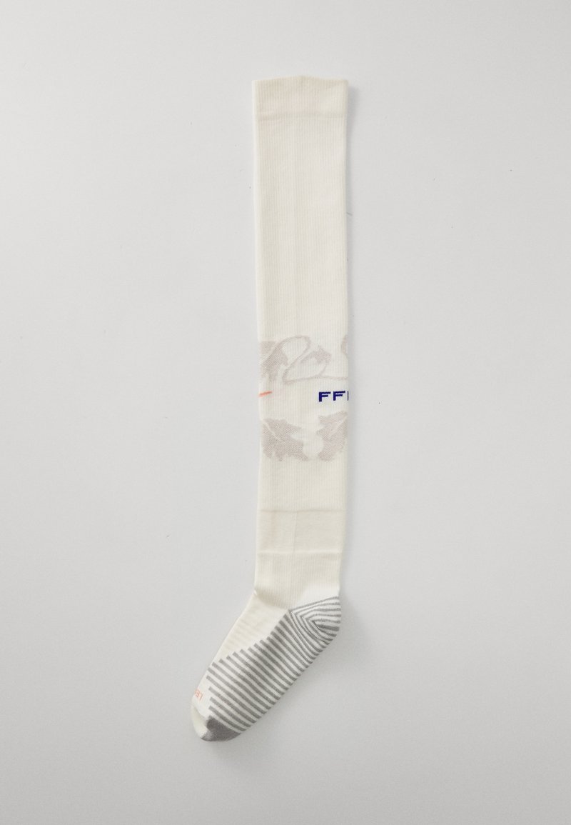 Meia longa, de cor creme, com um padrão floral discreto, apresentando uma secção do pé em azul listrada e texto azul. Tecido suave com um design canelado.