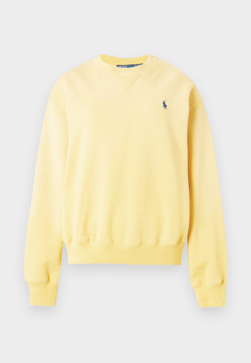 Sweat-shirt en coton jaune à manches longues, avec poignets et ourlet côtelés. Il présente un petit logo cheval bleu marine sur le côté gauche de la poitrine.