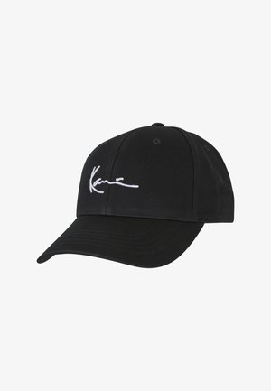 Black baseball cap made of textured fabric, featuring a white embroidered signature on the front, with a curved visor and ventilation holes.